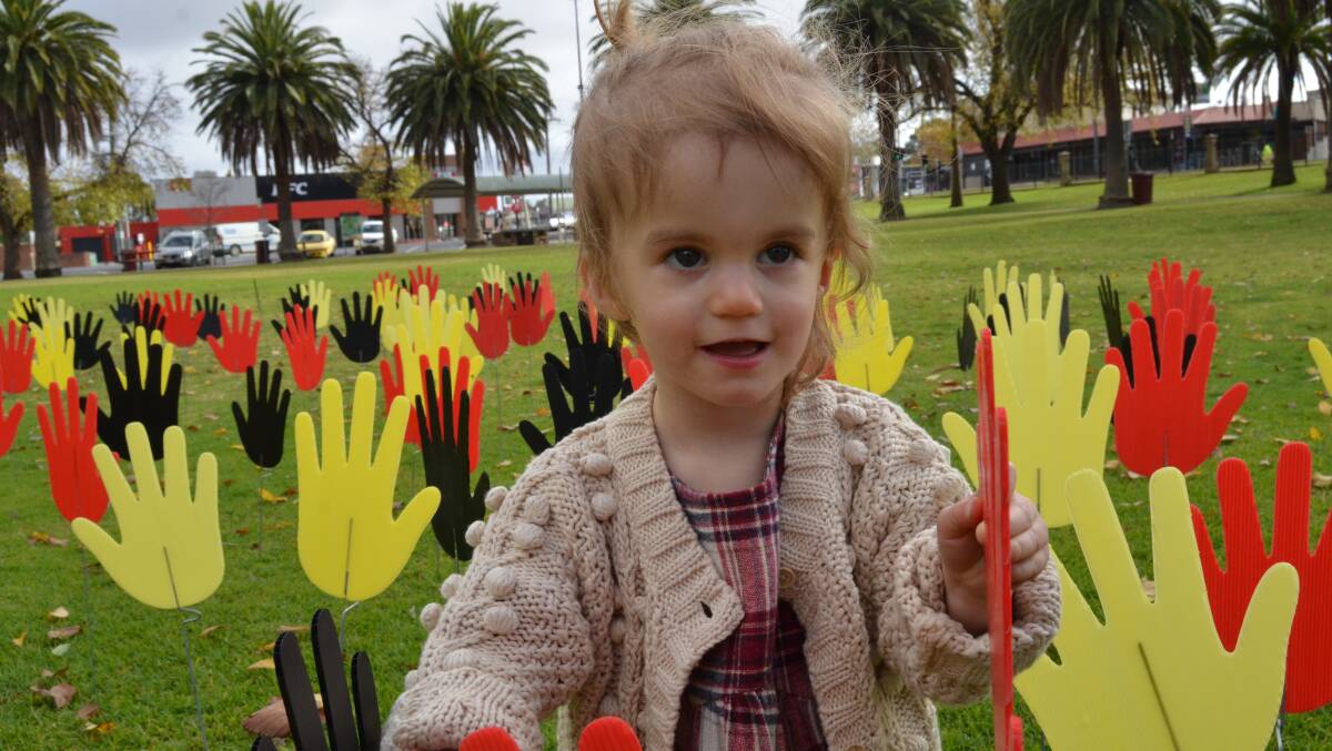 HANDS ON: Reconciliation Week was cut short earlier this year due to a circuit breaker lockdown. Finley Davidson, 2, was still able to show her support. Picture: ALISON FOLETTA