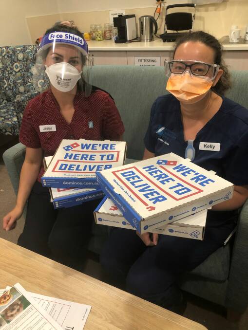 PIZZA PARTY: Wimmera Base Hospital nurses Jessie and Kelly enjoy their well earned pizza treat. Picture: CONTRIBUTED