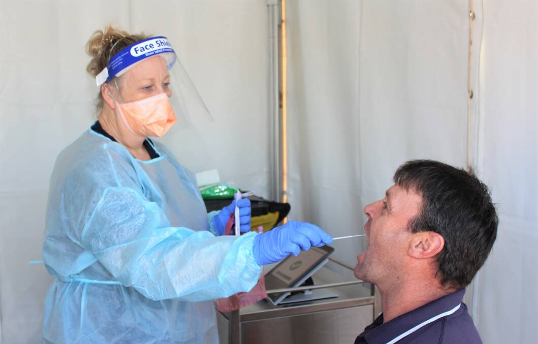 RECORD: Fully vaccinated truck driver Anthony Vincent getting swabbed by nurse Deidre Harrington. Picture: CONTRIBUTED