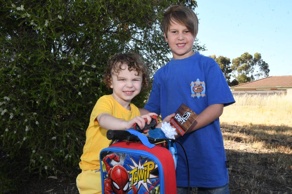 TOUCHING: Elijah (left) was all smiles after receiving a bike and $50 voucher from Jayden. Picture: ALEX DALZIEL
