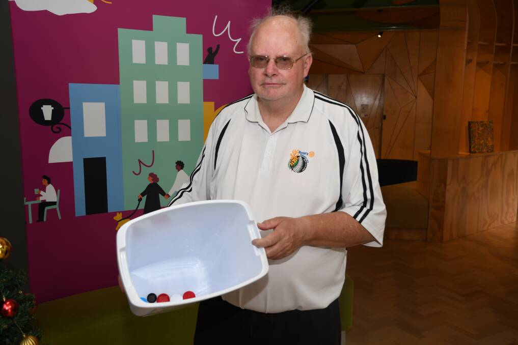 DONATION: Horsham Rotary Club president Neil King looks at the Mail-Times' lid collection. Picture: ALEX DALZIEL