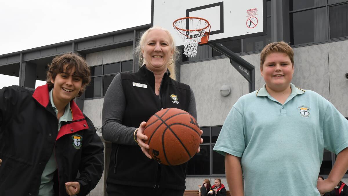HOOPS: St Brigid's students Dominik Trebicki and Darcy Taylor with Sharon Fedke at the school's new basketball court. Picture: ALEX DALZIEL
