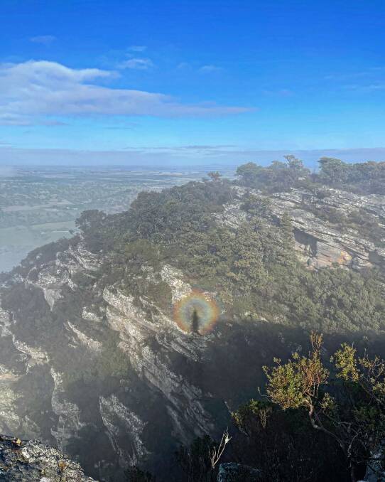 LIGHT: Inside the ring of rainbow one can spot the figure of a person, or spectre, the enourmous shadow cast as a result of a low sun and high clouds. Picture: ALICE GUBBINS