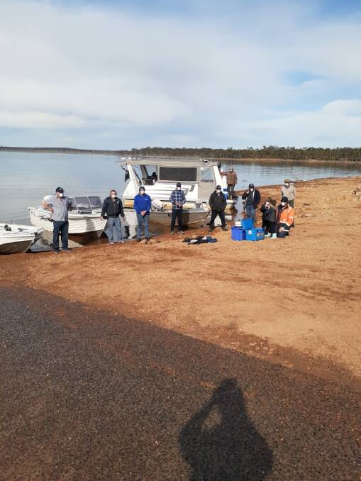 BOATING: Balmoral Angling Club members helping Victoria Fisheries Authority with one of their fish stocking releases. Picture: CONTRIBUTED