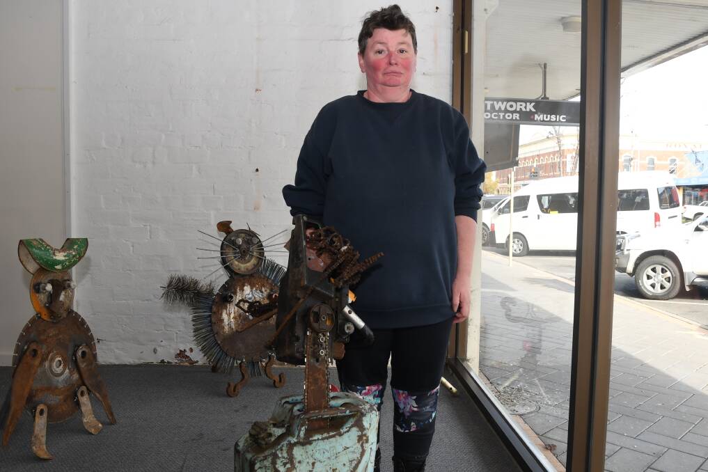 CHAINSAW: Kim Graham with her sculpture, which she said was inspired by chainsaw massacres. Picture: ALEX DALZIEL