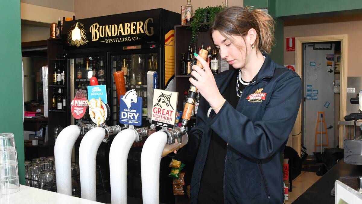 EXCISE: Ashton Murray pours a beer at the Exchange Hotel. Picture: ALEX DALZIEL