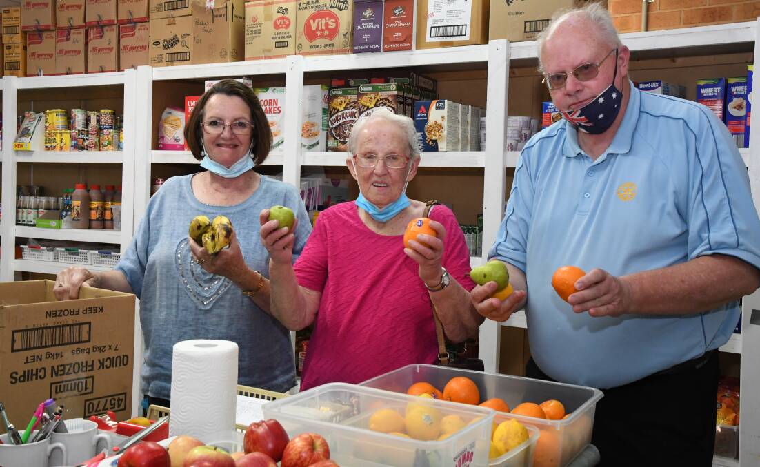 FOR THOSE IN NEED: Christian Emergency Food Centre volunteer Lynda Hutchinson (left), founding member Florence Webb and Horsham Rotary president Neil King look to stock the centre's shelves with donated goods. Picture: ALEX DALZIEL