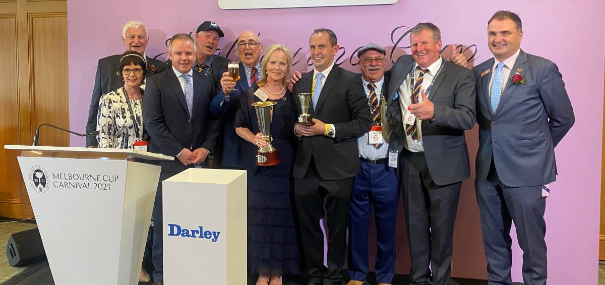JOY: Some of Nature Strip's owners, including Horsham's Craig Garland, Craig Bennett and Geoff Dumesny, pose with trainer Chris Waller after Nature Strip took out the Darley Sprint Classic at Flemington on Saturday. Picture: CONTRIBUTED