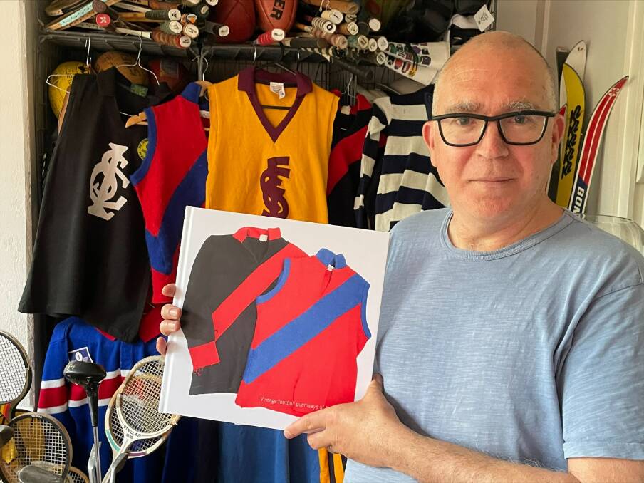 AVID COLLECTOR: Tim Rath poses with an early version of his book and his personal collection of vintage football jumpers from across Australia. Picture: CONTRIBUTED