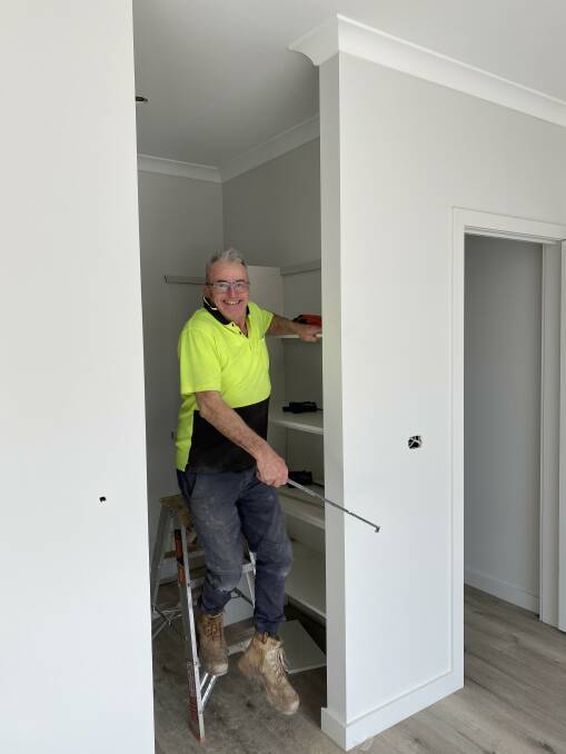 SUPPLY SHORTAGE: Carpenter Wayne Lane of RJ Lee Construction hard at work installing shelves in a home. Picture: CONTRIBUTED