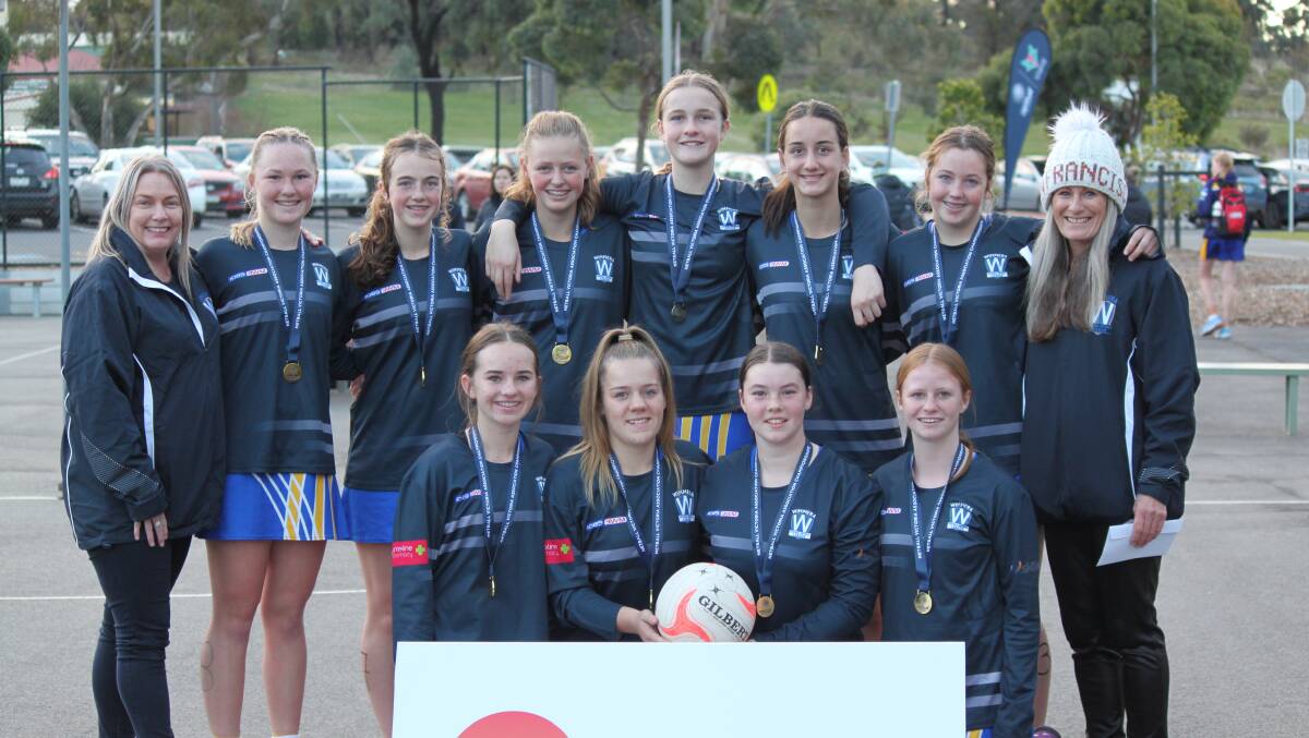CHAMPIONS: Team manager Scoot Mentha (L) and coach Linley Wardle (R) with the under 15 Wimmera netball side after their win in Bendigo. Picture: JOANNE ORR
