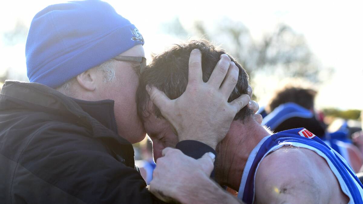 TENDER: John Delahunty shares a moment with older brother Chris after the Burras' 2019 grand final victory. Picture: MATT CURRILL
