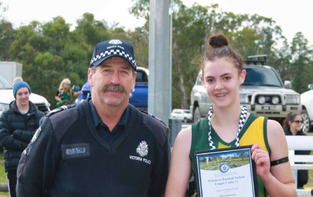 GOOD SPORT: Olivia Riemann receiving her award at the netball from Dimboola police officer Neil Zippell at the Dimboola Netball Courts. 