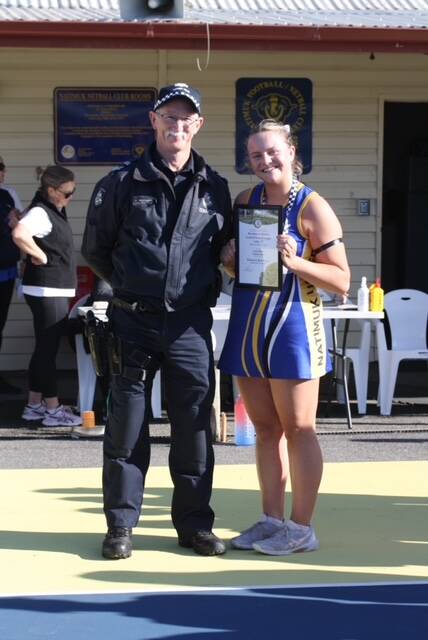 Natimuk United's Acacia Blake receives his Blue Ribbon Foundation Spirit of Sport award from Natimuk police officer Leading Senior Constable Peter Mellington. Picture supplied 