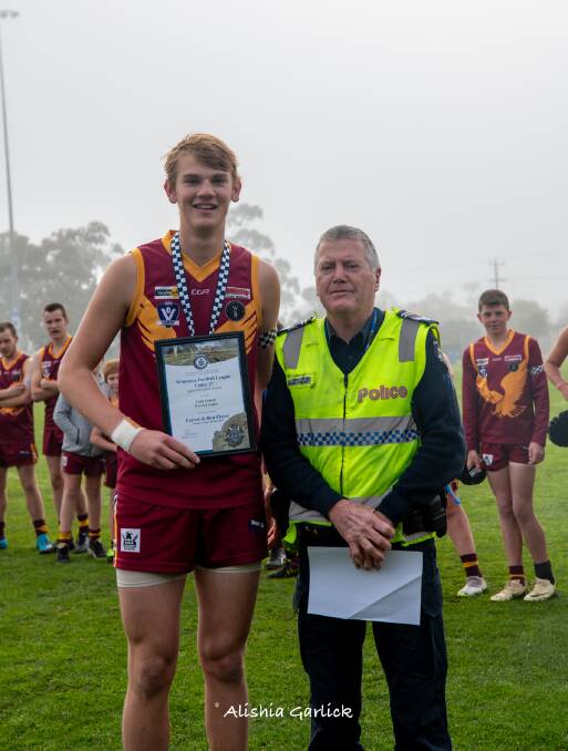 Warrack Eagles' footballer Cody Polack receives his Blue Ribbon Foundation Spirit of Football award from Warracknabeal police officer Leading Senior Constable Peter Taylor. Picture supplied