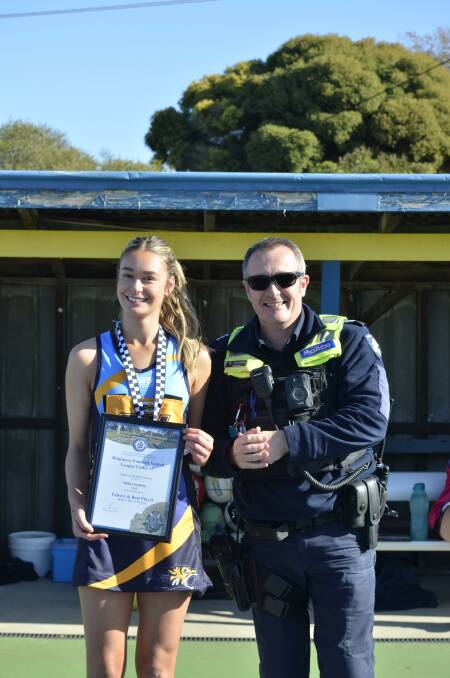 Milla Goodwin receives her Blue Ribbon Foundation Spirit of Netball award from Nhill police officer Sergeant Matt Kennedy. Picture supplied