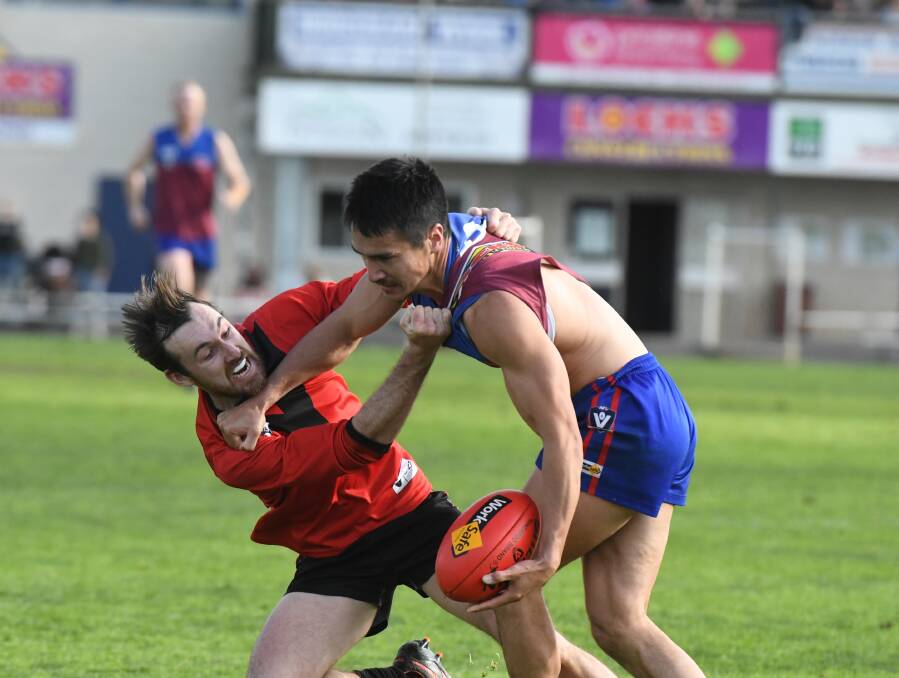 Demons coach Tyler Blake fends off a Stawell opponent in 2022. File picture. 