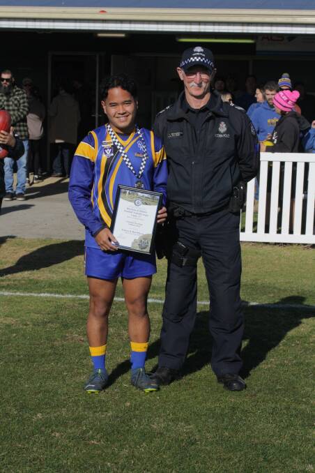 Natimuk United footballer Christian Macalinga receives his Blue Ribbon Foundation Spirit of Sport award from Natimuk police officer Leading Senior Constable Peter Mellington. Picture supplied 
