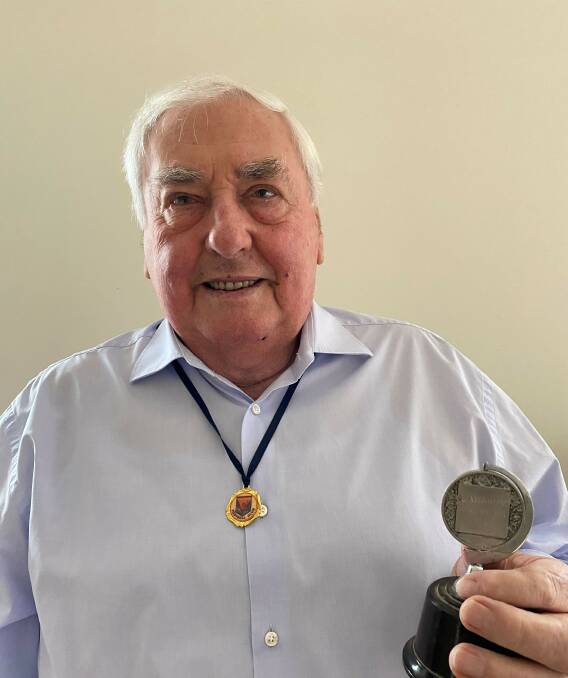 Donald Carter shows off his 1958 premiership medallion, earned by the club during his first tenure as secretary. Picture supplied
