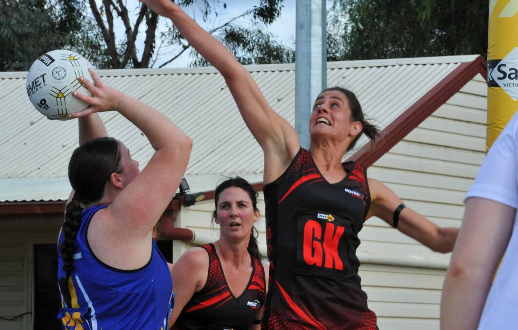 Noradjuha-Quantong goal keeper, Stephanie Cooper reaches to block Natimuk United goal shooter, Ebony Klowss in round three of the HDFNL at the Natimuk Showgrounds on Saturday, April 29. Picture by John Hall.