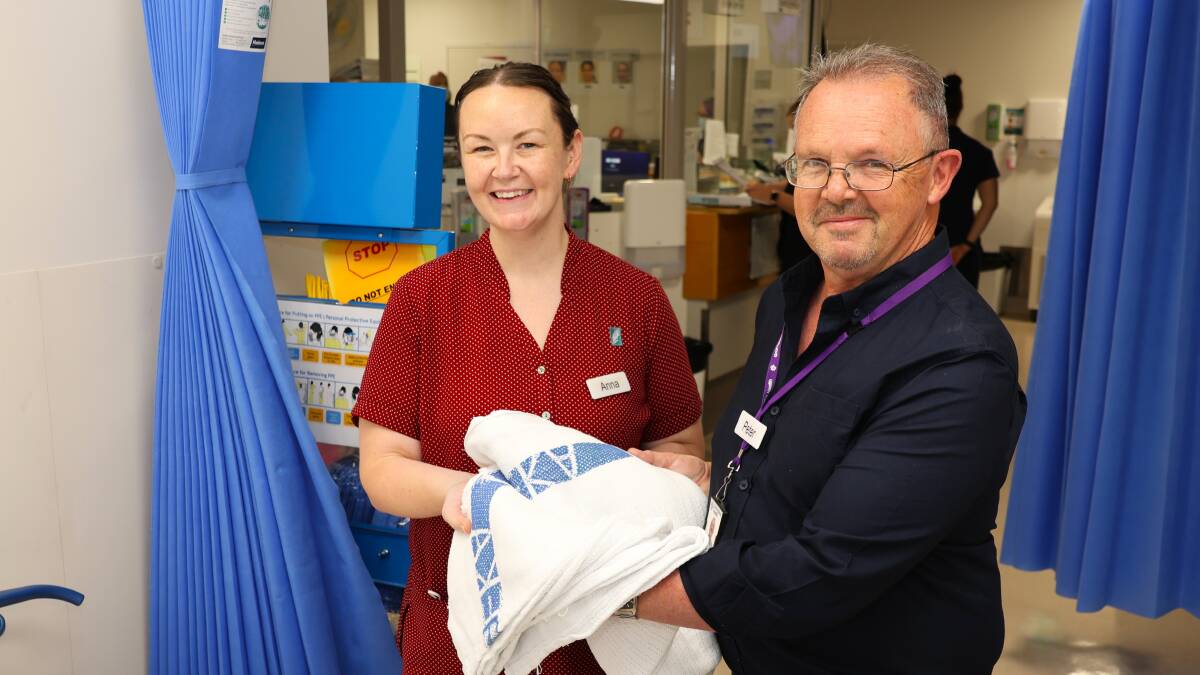 Volunteer Peter Anthony helps ED registered nurse Anna Tepper to change bedding. Picture supplied