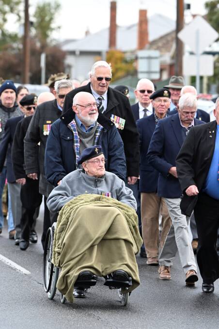 WWII veteran John Andrew, aged 99, takes part in the 2024 Anzac Day march in a wheelchair purchased by the Sebastopol RSL. Picture by Lachlan Bence