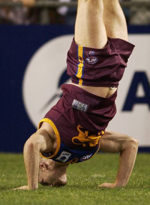 Akermanis doing one of his famous handstands, kissing the ground, for the Brisbane Lions. Picture by Getty Images