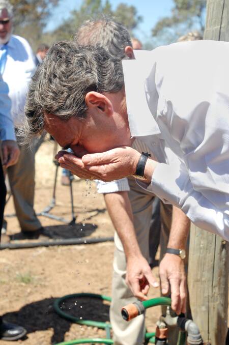 Victorian Premier, John Brumby, drinking water from the pipeline while visiting Rob McRae's farm in Wallup in 2008. File picture
