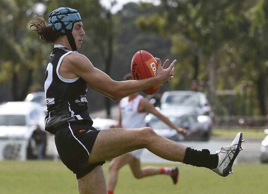 Khy Jess of the Rebels is acrobatic in his control of the football in the come-from-behind win over the Sydney Swans Academy. Picture by Lachlan Bence