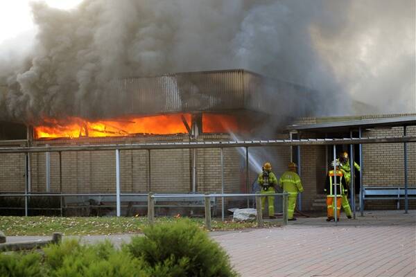 Horsham Fire Brigade fire fighters work to control a fire in the Claude Brand Library at Horsham College. Pictures: PAUL CARRACHER