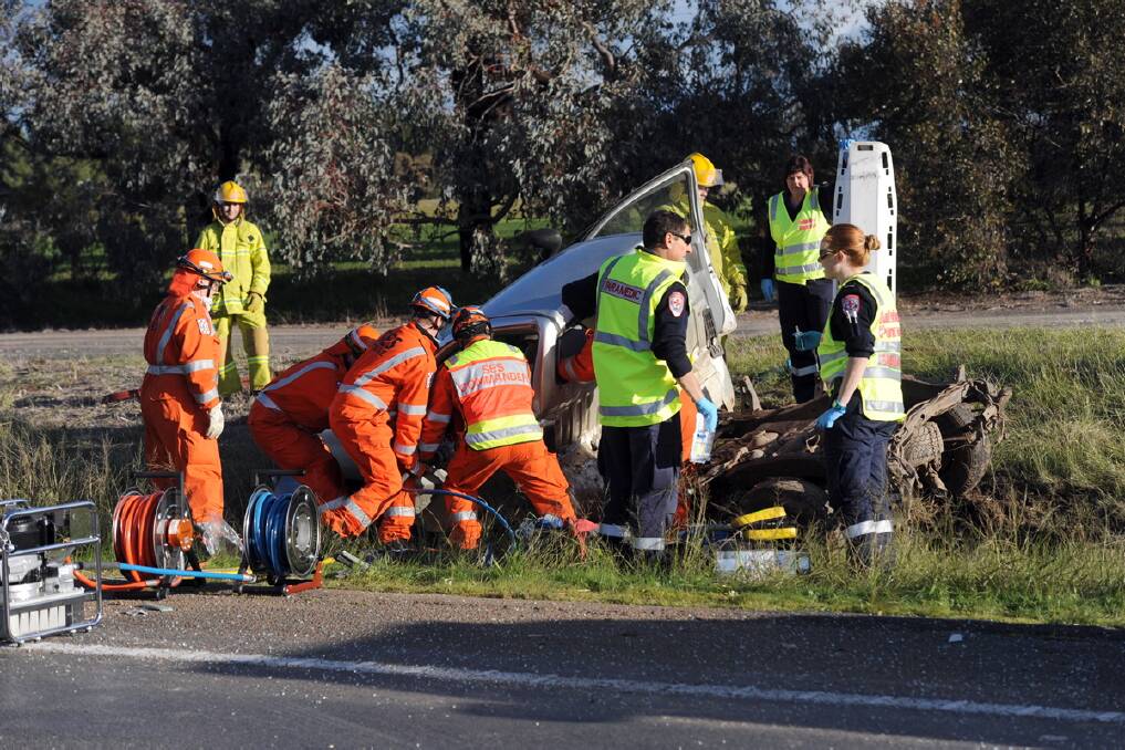 CRASH: Emergency services work to free the female passenger in a ute after a crash on the Western Highway near Green Lake. Picture: PAUL CARRACHER 