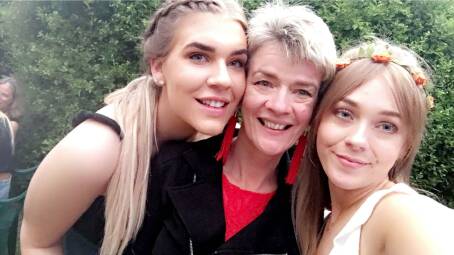 Grace and Lucy with their Mum, Ruth McIntyre. Mother and daughters proudly wear the tattoo of a monarch butterfly chosen by Ruth because they are deaf. Picture supplied